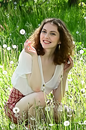 Julia Jacobs rides barefoot through flowers in a plaid mini skirt and crop top